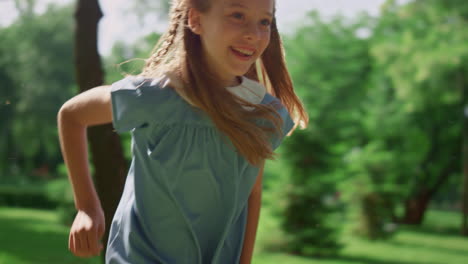 Smiling-girl-running-on-soft-grass.-Happy-kid-playing-active-game-on-nature.