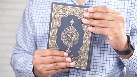 man holding the quran