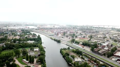 drone view of the industrial part of st. petersburg, kanonersky island with western high-speed diameter and the gulf of finland on the horizon