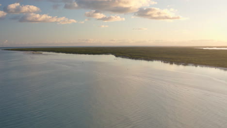 calm sea coastline with trees below dusking sky with clouds, mexico
