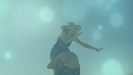 reaching upwards, person surrounded by dreamy blue bokeh animation lights
