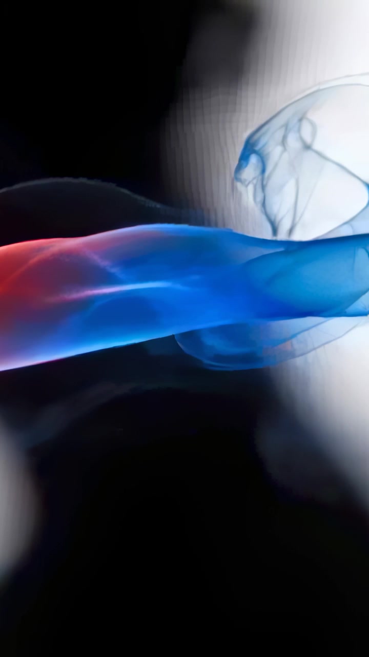Vertical video: Entering blue-and-red smoke ribbon curling toward bright light meeting smoke bubble
