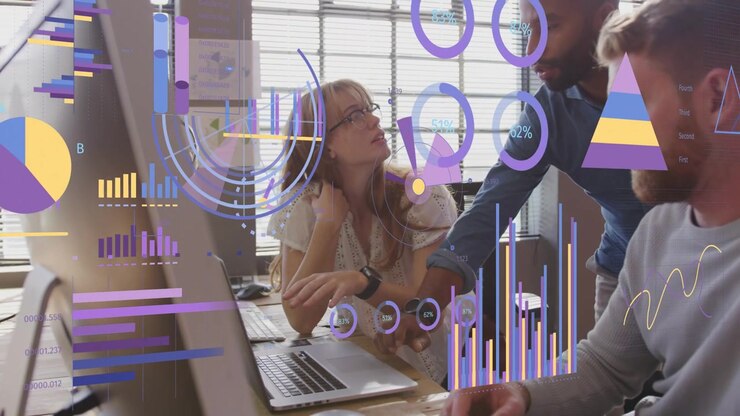 Team collaborating, standing man pointing at monitor, animated charts on screens guiding business