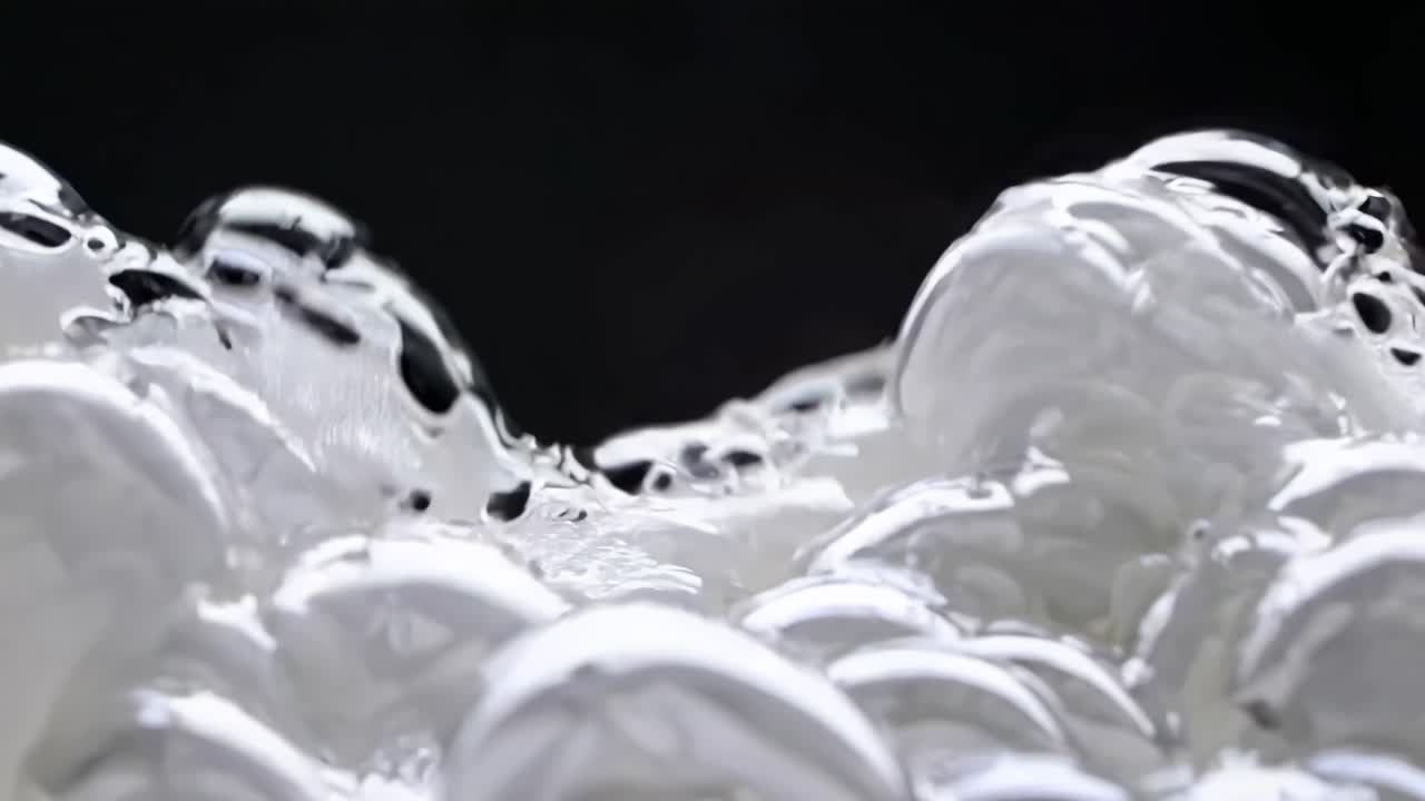 Close-up video of soap bubbles with a macro lens, highlighting intricate details and reflections
