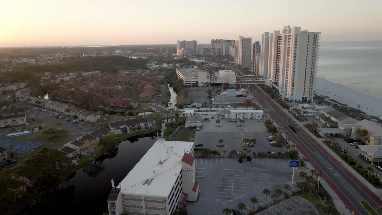 Early morning in Panama City Beach, Florida showing hotels and Gulf of America with drone video moving in.