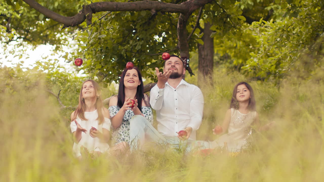 Family Juggling Apples in the Park