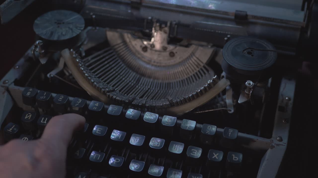 Man Prints With Vintage Soviet Typewriter in the Dark