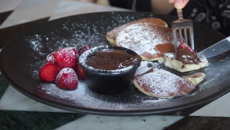 delicious pancakes with strawberries and chocolate sauce