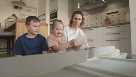 family organizing kitchen items