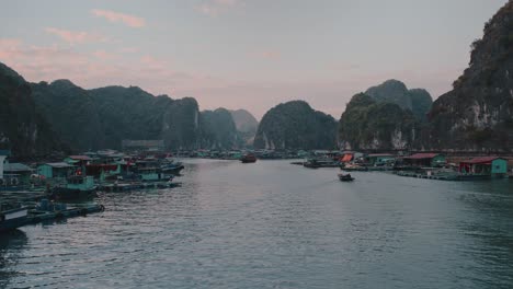 Forward-drone-shot-of-boats-parked-at-shore-of-river-of-Lan-Ha-Bay-in-Vietnam