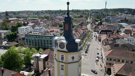 4k aerial drone video of the historic herrieder clock tower in the old town area of downtown ansbach, germany