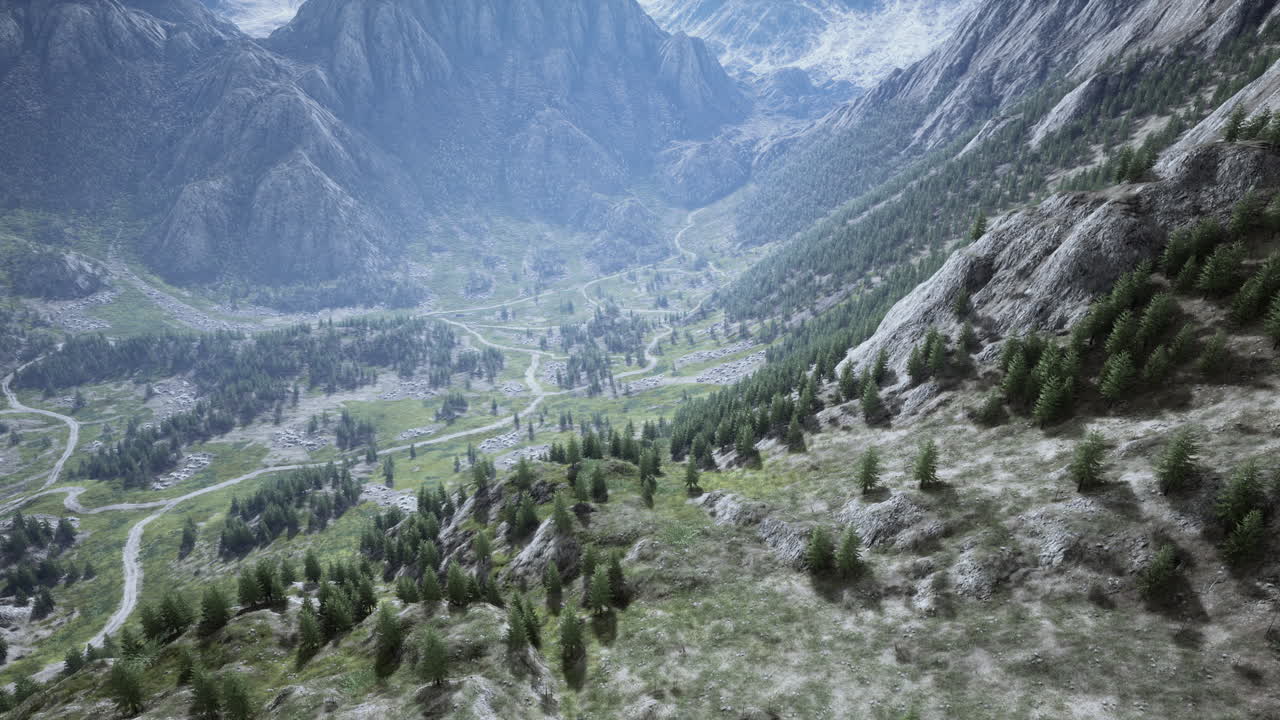 vista aérea de un valle montañoso con carreteras sinuosas y bosque exuberante