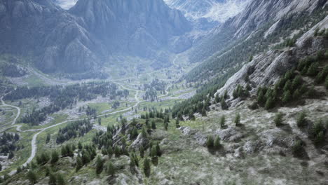 aerial view of a mountain valley with winding roads and lush forest