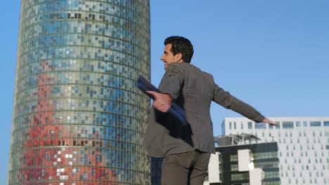 joyful businessman walking on street. entrepreneur jumping in air outdoors