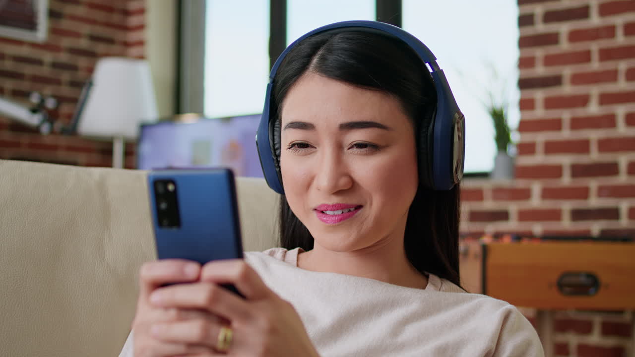 Woman listening to music on her smartphone with headphones