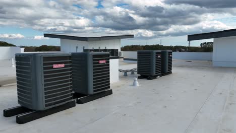 aerial close up of modern goodman air conditioner on rooftop from apartment building. cloudy day in autumn season. virginia, usa. fresh cooling system for luxury houses.