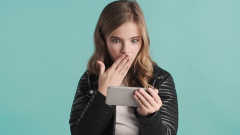 teenage caucasian girl video calling on her smartphone.