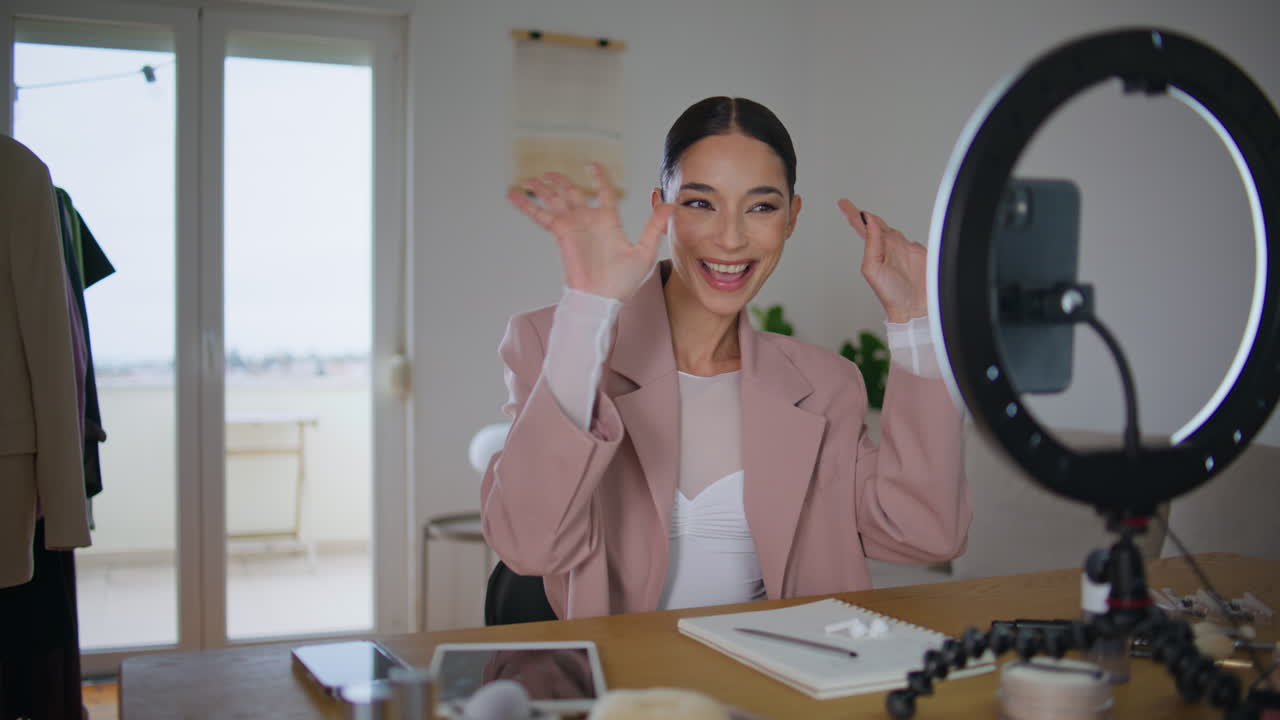 Beauty blogger greeting subscribers talking smartphone. Woman creating content