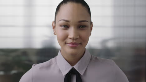 portrait of confident young mixed race business woman looking serious at camera wearing stylish fashion in office workspace