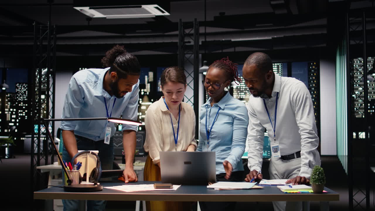Portrait of associates team collaborating in office environment at night