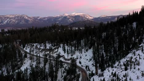 Cars-Driving-At-Mountain-Road-With-Coniferous-Forest-At-Winter