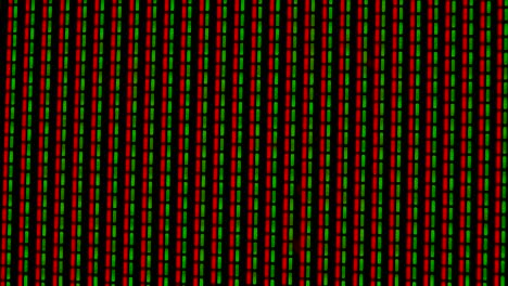 working pixels in the screen color tv, with a video playback close up. green and red pixels flicker against a black background. macro