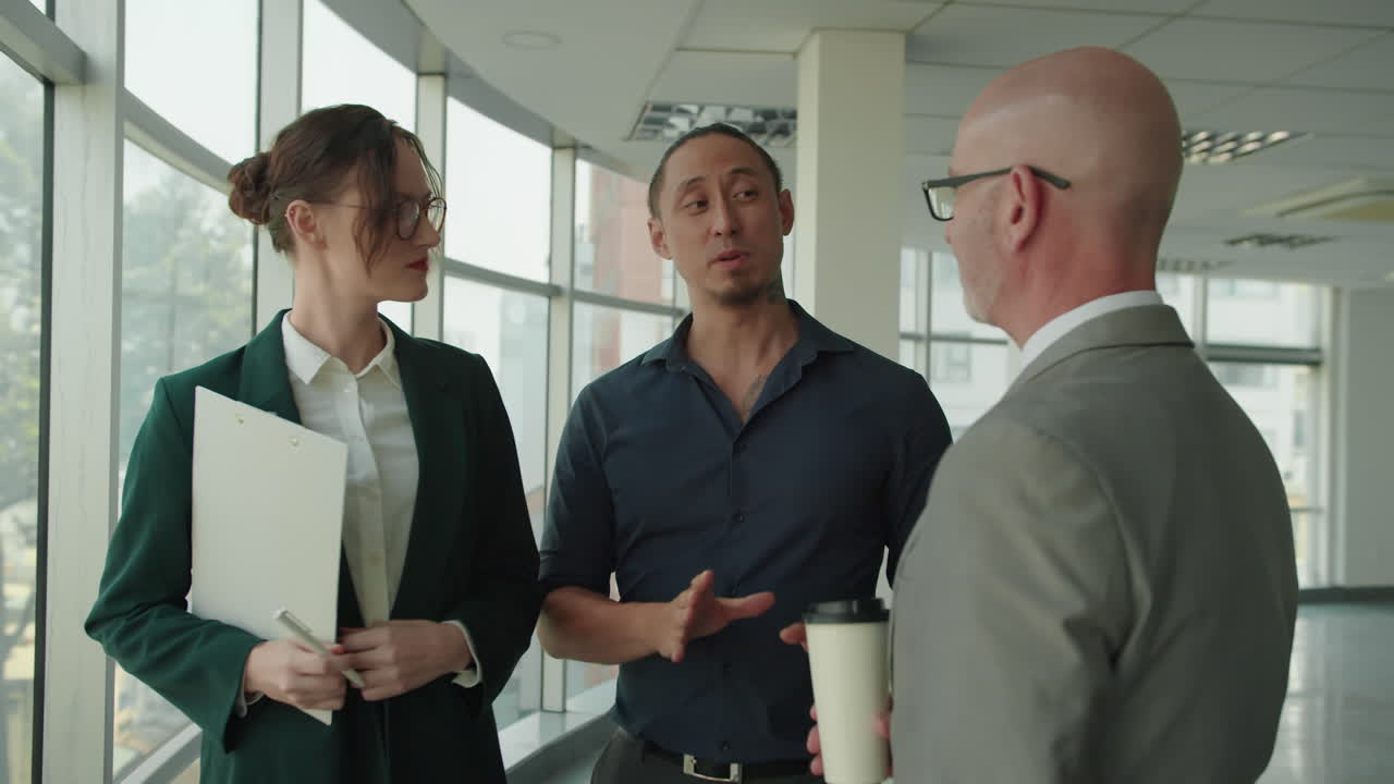 Three Diverse Office Employees Talking during Coffee Break at Office
