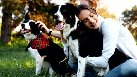 beautiful couple walking dogs and bonding in nature