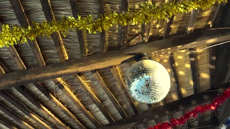 rustic thatched roof with disco ball and christmas decorations