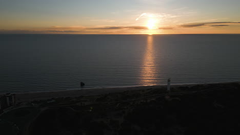 beautiful sunset over calm sea horizon, aerial view