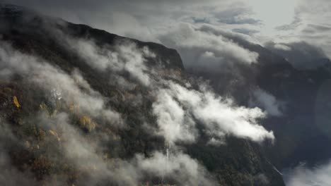 heavy clouds whirl above the magnificent geiranger fjord