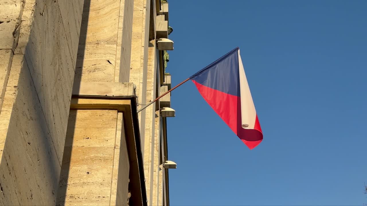 Czech flag waving on building at sunset