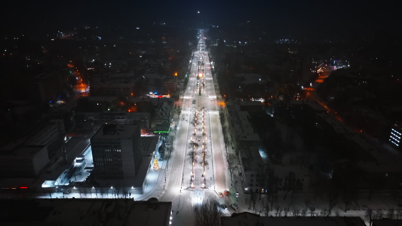 Aerial drone view of Chisinau city covered in snow at night, blue hour. Moldova