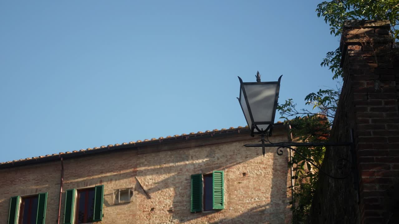 Vintage Street Lamp on a Brick Building in Tuscany, Italy