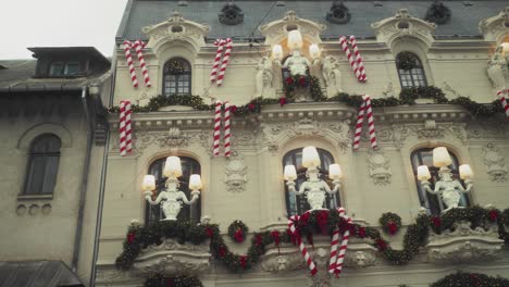 panning right shot reveals a christmas-decorated art nouveau building in bucharest - "mița biciclista" house