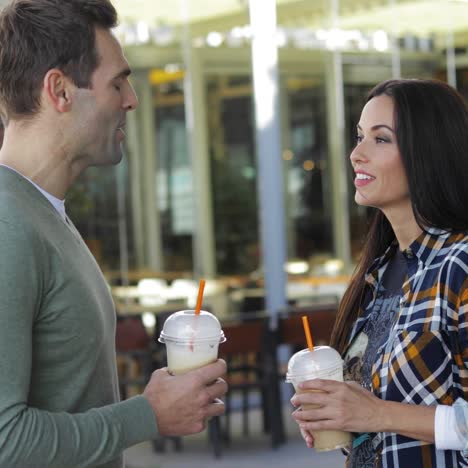 Young-couple-drinking-takeaway-beverages