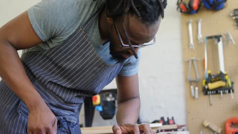 carpenter measuring wood with measuring tape 4k