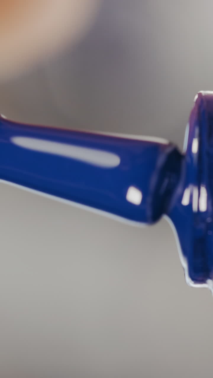 Close-up of Dropping Blue Nail Polish