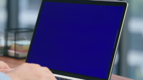 closeup man arms texting blue screen laptop. smart ceo typing pressing buttons