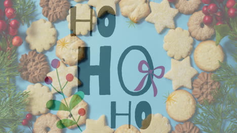 ho text animation over christmas cookies on blue background