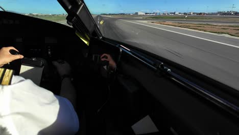 Right-shoulder,-arm-and-hand-of-a-white-pilot-illuminated-by-the-sunlight-during-a-real-time-takeoff-from-the-runway