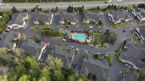 Establishing-aerial-view-of-an-apartment-community-with-a-pool-and-clubhouse