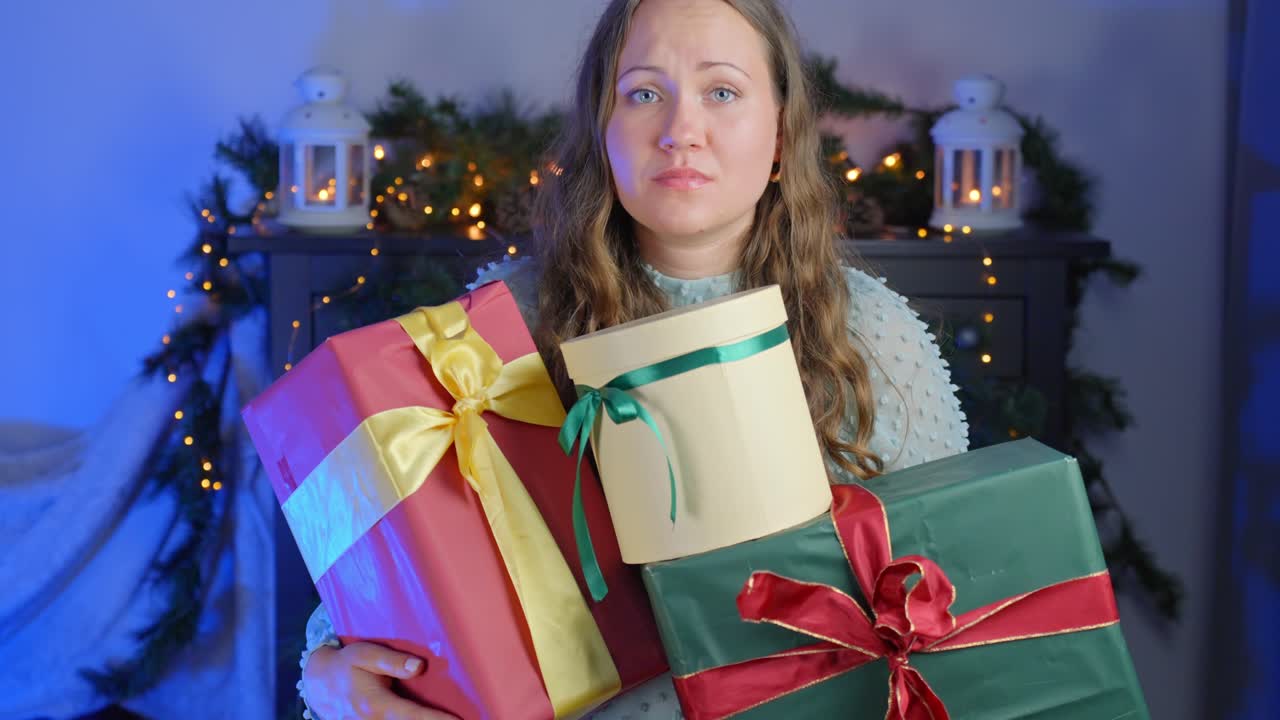 Woman feeling unhappy over gifts she's holding towards camera, static closeup