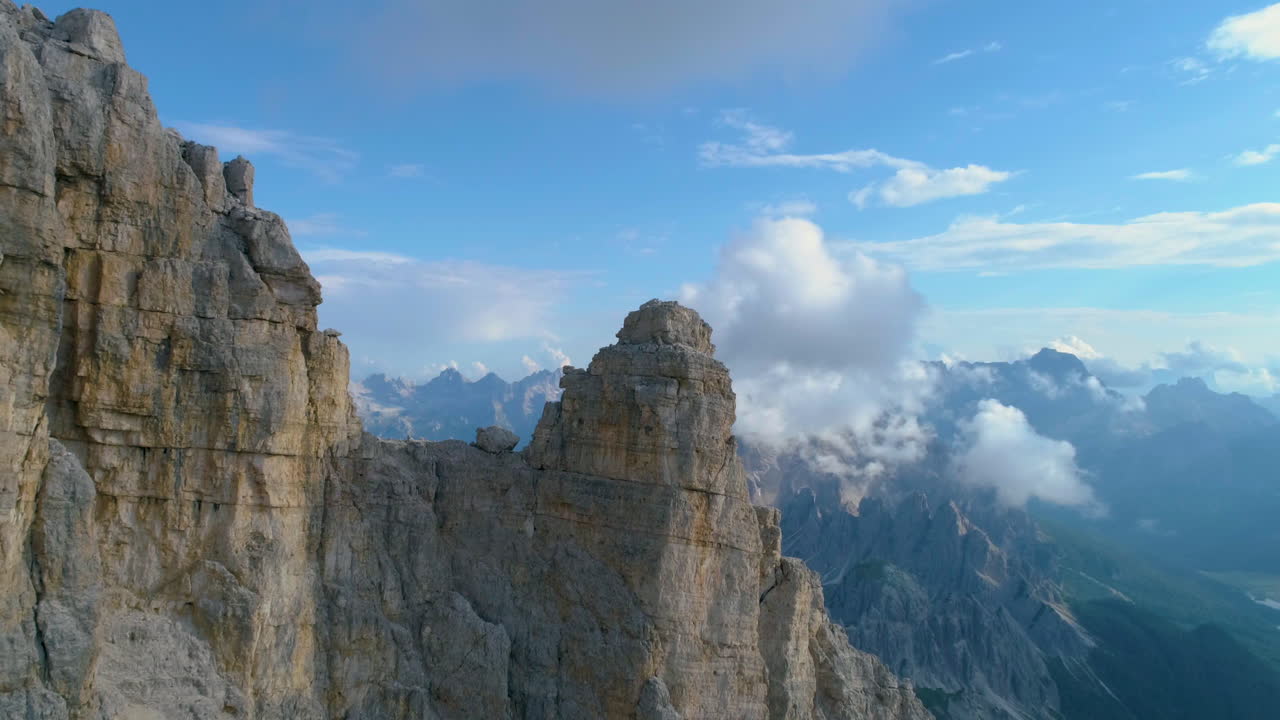 Veduta aerea ad alta quota delle vette delle Tre Cime in Alto Adige che rivela il terreno montuoso delle Dolomiti in lontananza.