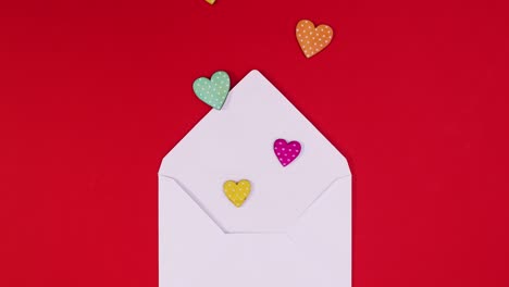 envelope appear on red theme and hearts come out. looping stop motion