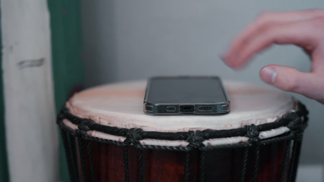 Man hand grabbing smartphone on table nightstand next to bed, reaching to mobile phone in morning evening living in social digital world.