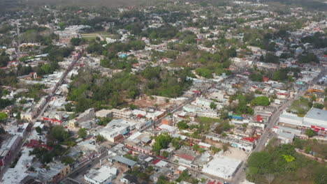 Aerial-panoramic-footage-of-town-with-plenty-of-greenery.-Development-surrounded-by-tropical-forest.-Valladolid,-Mexico