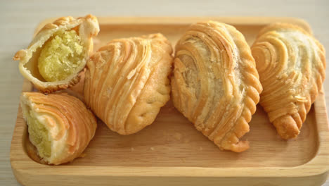 curry puff pastry stuffed beans on wooden plate