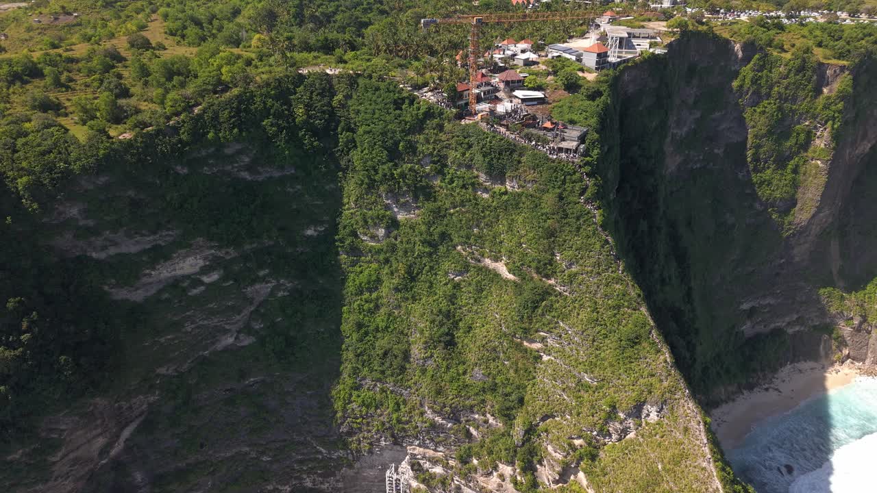 Aerial reveal of controversial glass elevator construction at Kelingking Beach, Nusa Penida