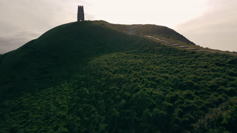 a drone shot ascending glastonbury tor